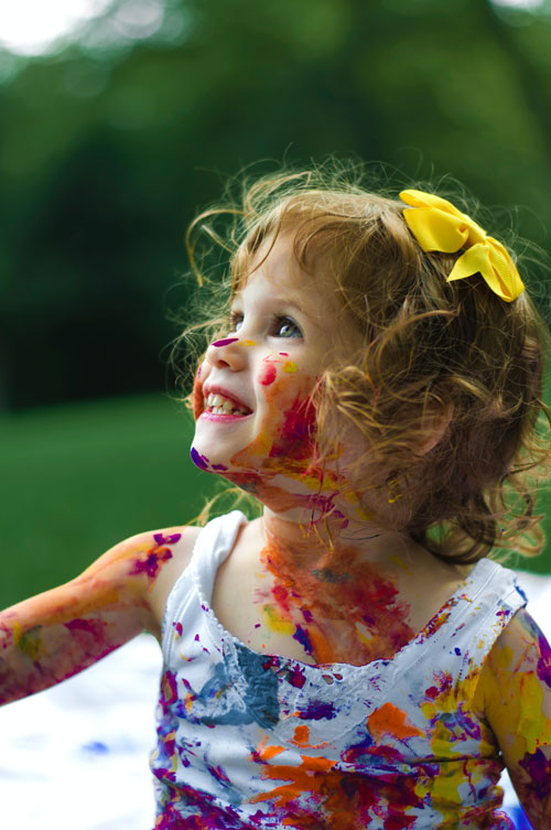 Young girl covered in paint